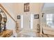 Inviting foyer with hardwood floors, staircase, and natural light streaming through window accents on the front door at 3258 Kessock Ridge Trl, Snellville, GA 30039