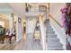 Bright foyer featuring hardwood floors, staircase with wood railing, and soaring ceilings for a grand entrance at 3258 Kessock Ridge Trl, Snellville, GA 30039