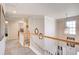 Spacious upstairs hallway with staircase and decorative mirrors at 3258 Kessock Ridge Trl, Snellville, GA 30039