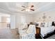 Spacious main bedroom featuring tray ceilings, ceiling fan, and a cozy sitting area at 3258 Kessock Ridge Trl, Snellville, GA 30039