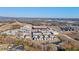 An aerial view shows a mixed-use development with apartments, townhomes, and commercial buildings near a highway at 6750 Avis Walk, Alpharetta, GA 30005