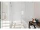 Modern bathroom featuring glass enclosed shower, bench, and wooden shelf for towel and cosmetic storage at 6750 Avis Walk, Alpharetta, GA 30005