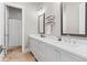 Bathroom featuring dual sinks, white cabinets, modern fixtures, and a mirror on the wall at 6750 Avis Walk, Alpharetta, GA 30005