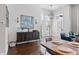 Elegant dining area with a decorative sideboard, high ceilings, large windows, and a dining table at 6750 Avis Walk, Alpharetta, GA 30005