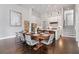 Dining room features a large wooden table, seating for eight, and open view of the modern kitchen at 6750 Avis Walk, Alpharetta, GA 30005