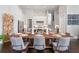 Dining room features a large wooden table, seating for eight, and open view of the modern kitchen at 6750 Avis Walk, Alpharetta, GA 30005