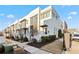 Modern townhouse complex featuring brick facade, awnings, dark framed windows, and professional landscaping at 6750 Avis Walk, Alpharetta, GA 30005