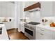 Modern kitchen with stainless steel appliances and white cabinets with countertops and dark wood floors at 6750 Avis Walk, Alpharetta, GA 30005