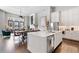 Bright kitchen with stainless steel appliances, white cabinets and countertops, and a view into the dining and living areas at 6750 Avis Walk, Alpharetta, GA 30005