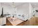 Bright living room with light gray walls and wood floors, a white sofa, and a modern coffee table at 6750 Avis Walk, Alpharetta, GA 30005