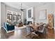 Open-concept living space with living room, fireplace, dining area and dining table at 6750 Avis Walk, Alpharetta, GA 30005