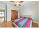 Bedroom with hardwood floors, ceiling fan, and double doors at 3172 Lynwood Ne Dr, Brookhaven, GA 30319