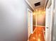 Hallway with gray walls, hardwood floors, and multiple doors at 75 Maygold St, Mcdonough, GA 30253