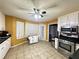 Eat-in kitchen with stainless steel appliances and white cabinets at 75 Maygold St, Mcdonough, GA 30253