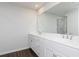 A bathroom with a double sink and a large mirror with a shower reflecting in the background at 726 Ocmulgee Xing, Locust Grove, GA 30248