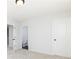 A bedroom with three doors, carpet, and a ceiling light at 726 Ocmulgee Xing, Locust Grove, GA 30248