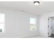 Bright bedroom with neutral carpet, two windows and a ceiling light at 726 Ocmulgee Xing, Locust Grove, GA 30248