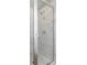 A frameless shower features marble-look tiles and a shower head at 726 Ocmulgee Xing, Locust Grove, GA 30248