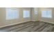 Well-lit bedroom with wood-look floors and multiple windows at 3293 Hobart Nw Dr, Atlanta, GA 30318