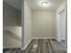 Upstairs hallway with wood-look floors and access to bedrooms at 3293 Hobart Nw Dr, Atlanta, GA 30318