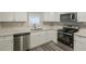 Modern kitchen with white cabinets, stainless steel appliances, and quartz countertops at 3293 Hobart Nw Dr, Atlanta, GA 30318