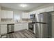 Modern kitchen with white cabinets, stainless steel appliances, and quartz countertops at 3293 Hobart Nw Dr, Atlanta, GA 30318