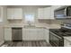 Modern kitchen with white cabinets, stainless steel appliances, and quartz countertops at 3293 Hobart Nw Dr, Atlanta, GA 30318