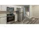Modern kitchen with white cabinets, stainless steel appliances, and quartz countertops at 3293 Hobart Nw Dr, Atlanta, GA 30318