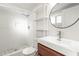 Modern bathroom features a shower with white subway tile, a vanity with shelving, and new fixtures at 1015 Deckner Sw Ave, Atlanta, GA 30310