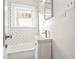 Small bathroom featuring white subway tile, a window, and modern fixtures at 1015 Deckner Sw Ave, Atlanta, GA 30310
