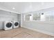 Clean laundry area with modern washer and dryer, bright windows, and functional shelving at 1015 Deckner Sw Ave, Atlanta, GA 30310