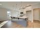 Kitchen with gray island, pendant lights, white cabinets and stainless steel appliances at 4511 Twinberry Dr, Powder Springs, GA 30127