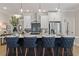 Kitchen island featuring pendant lighting, stylish blue stools, and stainless appliances at 4525 Twinberry Dr, Powder Springs, GA 30127