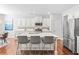 Bright kitchen with stainless appliances, white cabinets, and an island with barstool seating at 3330 Harmony Hill Rd, Kennesaw, GA 30144