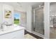 Luxurious bathroom with a glass-enclosed shower, a soaking tub, and views of outdoor greenery at 313 Chattahoochee Cir, Locust Grove, GA 30248