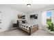 Cozy bedroom featuring a comfortable bed, soft lighting, and a window offering scenic views of the outdoors at 313 Chattahoochee Cir, Locust Grove, GA 30248