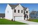 A delightful two-story residence with white brick, attached garage, and meticulously maintained lawn at 313 Chattahoochee Cir, Locust Grove, GA 30248