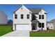 Charming two-story home features a white brick facade, attached garage, and well-manicured front lawn at 313 Chattahoochee Cir, Locust Grove, GA 30248
