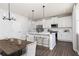 Bright kitchen boasts white cabinets, stainless steel appliances, island with seating, and pendant lighting at 313 Chattahoochee Cir, Locust Grove, GA 30248