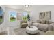 Relaxing living room featuring comfortable seating, lots of natural light, and plush carpet at 313 Chattahoochee Cir, Locust Grove, GA 30248