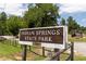 Indian Springs State Park sign with split-rail fence, landscaping, and welcome aesthetic at 313 Chattahoochee Cir, Locust Grove, GA 30248