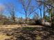 Backyard with a fire pit and a grassy area surrounded by trees at 854 Fayetteville Se Rd, Atlanta, GA 30316