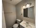Clean bathroom featuring a toilet, vanity sink, a framed mirror and modern lighting at 854 Fayetteville Se Rd, Atlanta, GA 30316