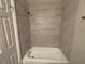 Bathroom showcasing a bathtub with tile surround and chrome fixtures at 854 Fayetteville Se Rd, Atlanta, GA 30316