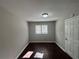 Bedroom with dark wood flooring, white door and a window providing natural light at 854 Fayetteville Se Rd, Atlanta, GA 30316