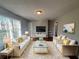 Bright living room featuring modern white sofas, a glass coffee table, and hardwood floors at 854 Fayetteville Se Rd, Atlanta, GA 30316