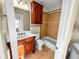 Full bathroom featuring a tub/shower combo, a cherry vanity, and neutral tile at 1054 Sw Morgan Garner Dr, Lilburn, GA 30047