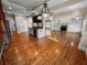 Open kitchen features hardwood floors, island, and built-in shelving at 1054 Sw Morgan Garner Dr, Lilburn, GA 30047