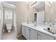 Bright bathroom features a double sink vanity and a separate toilet room at 3413 Talking Creek Ct, Conyers, GA 30094