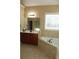 Bathroom with corner soaking tub, double vanity, and tile floors at 3413 Talking Creek Ct, Conyers, GA 30094